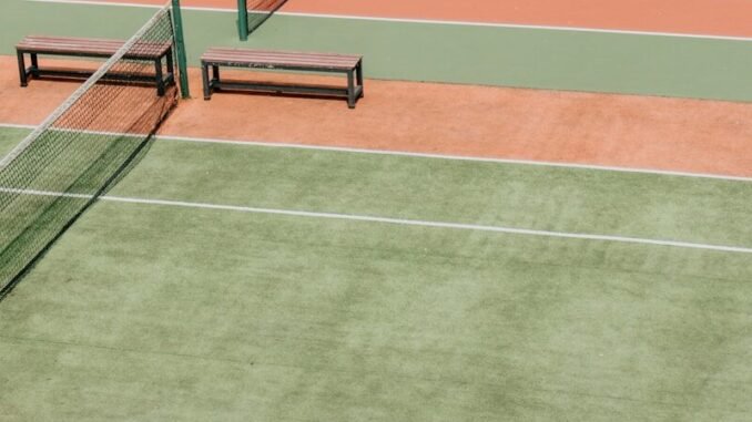 empty green and orange tennis fields